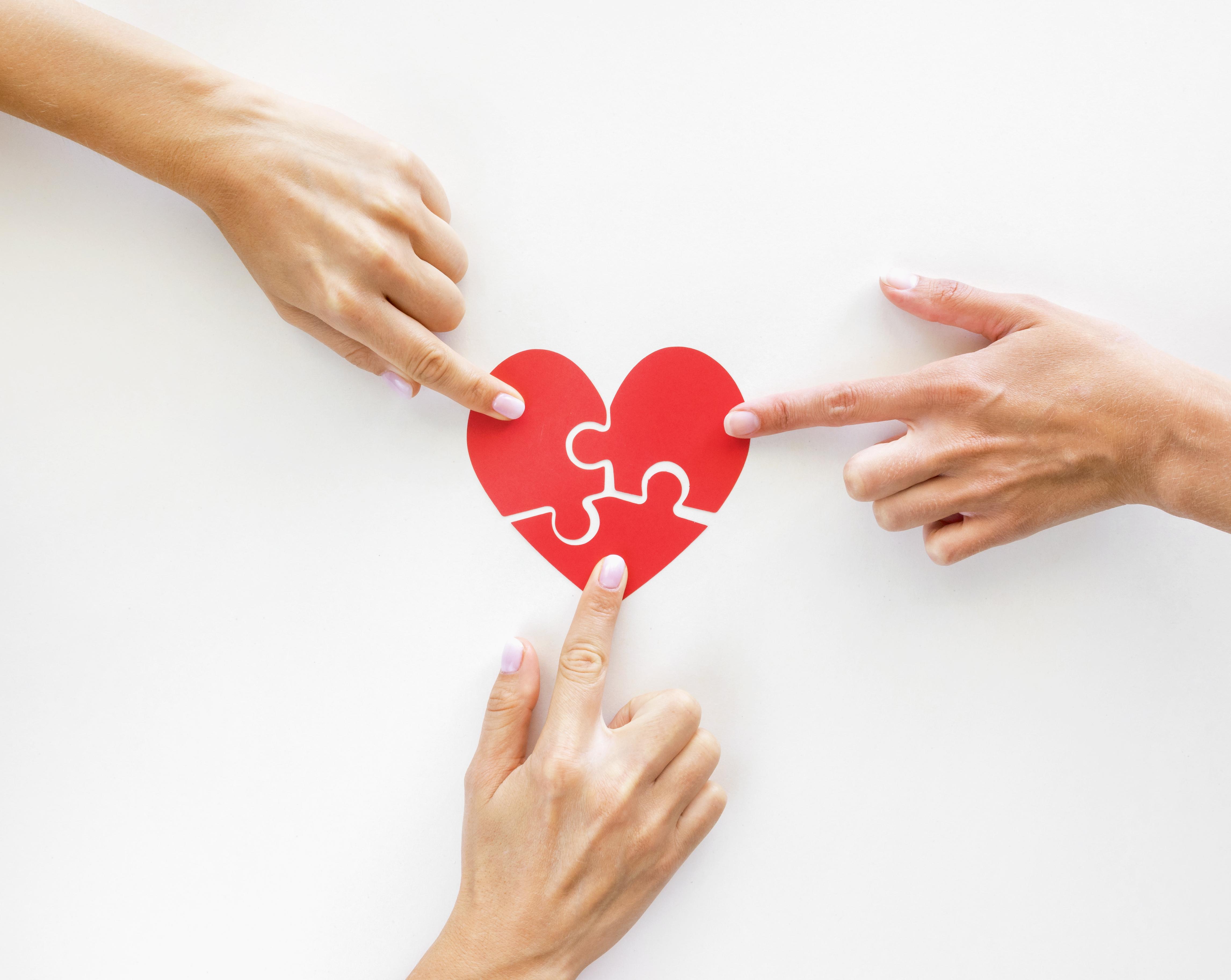 top-view-of-hands-touching-puzzle-heart-pieces.jpg